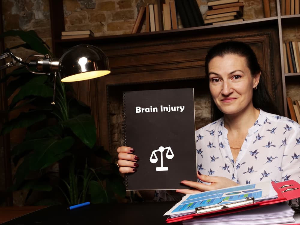 Legal concept pertaining to brain injury accompanied by a signature on a document.
