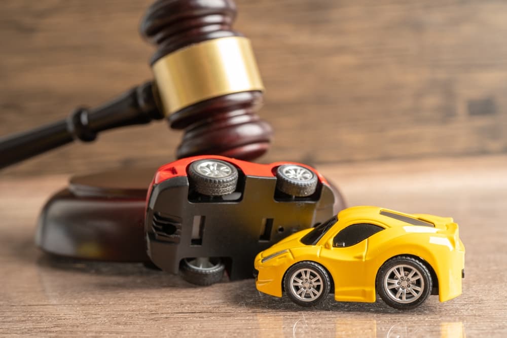Judge's gavel, car accident, insurance claim, lawsuit, court case.






